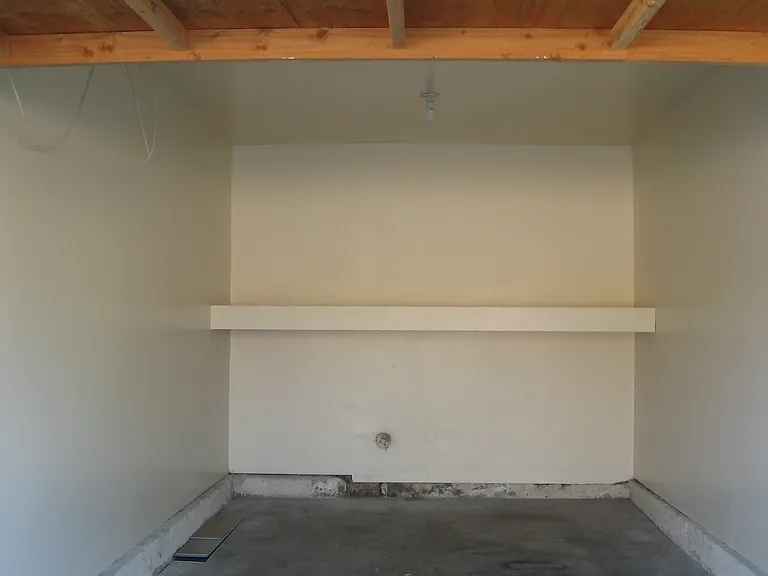 Large one car garage with storage area and extra electrical for extra frig.