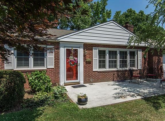 Charming front patio flanked by accent trees