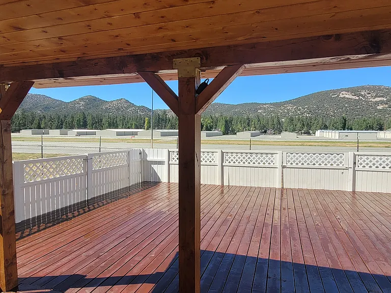 Attached wood Gazebo for patio furniture and shade.