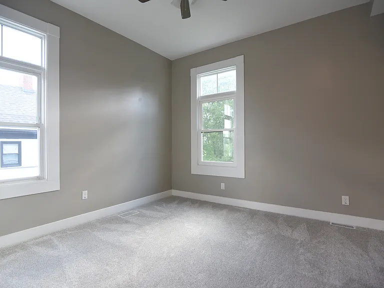 Bright and airy bedroom #3 faces rear yard.