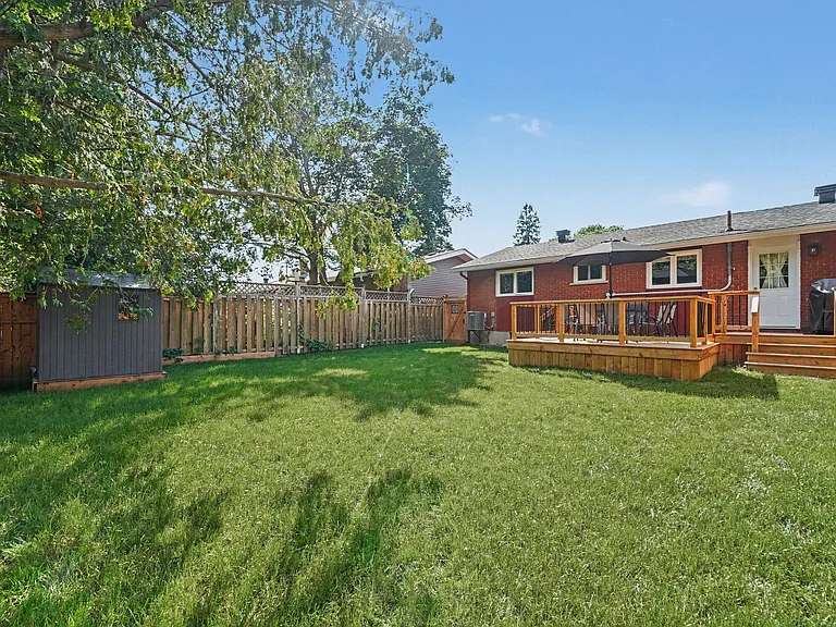 Private, fenced backyard with a deck_great for relaxing after a busy day.