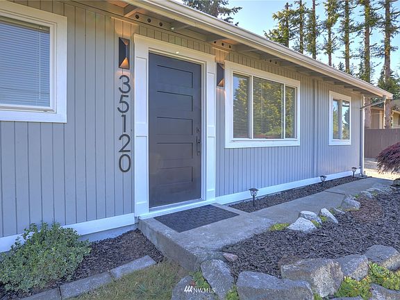 Fresh and modern landscaping . The front entry door is new and modern, complimented by the new outdoor lighting.