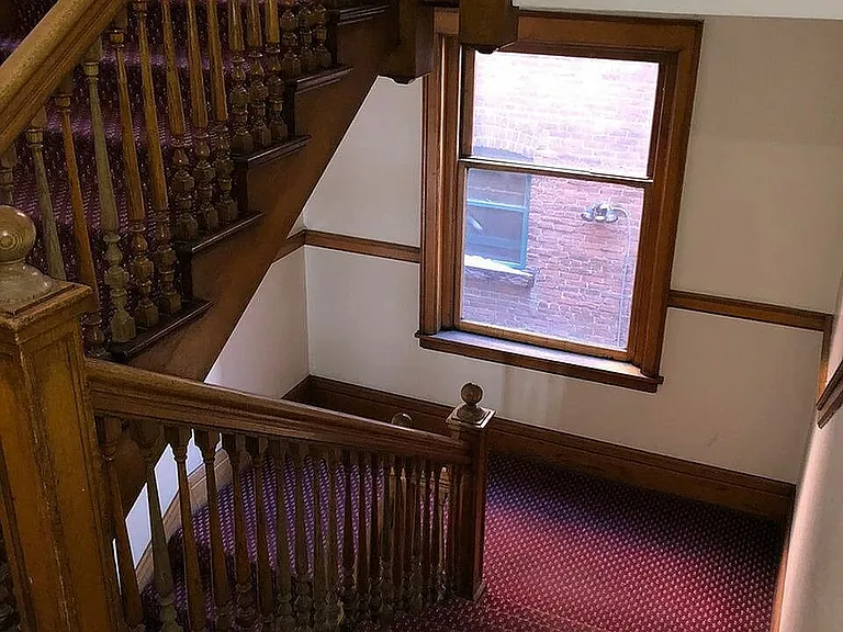 Step into elegance with this beautifully crafted wooden staircase, perfect for a warm and inviting home atmosphere.