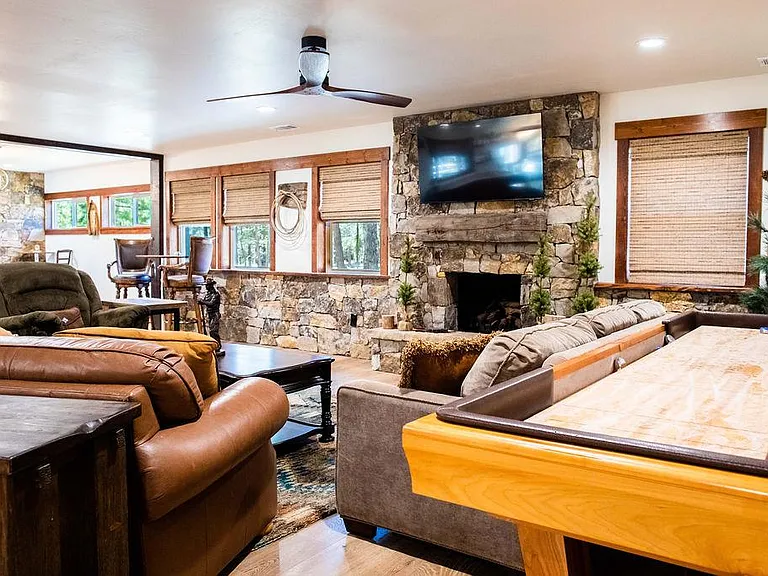 Living room with a smart TV and a shuffleboard table