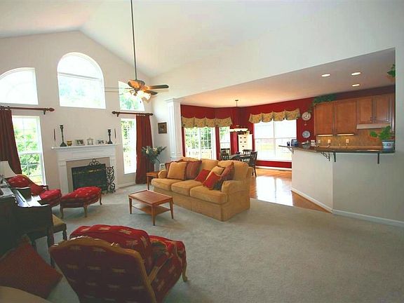 Open 2 story Family Room with wall of windows overlooking backyard.