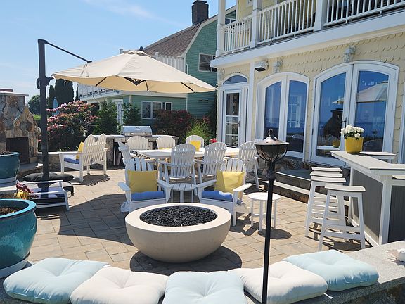 The patio with bar, fire pit and dining table.