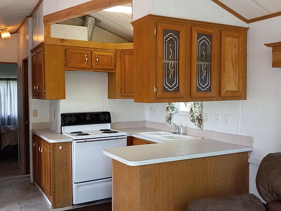 Kitchen with electric stove and refrigerator