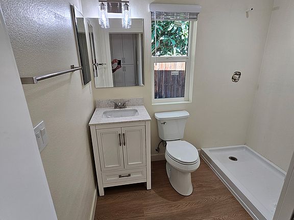 Bathroom with a shower and a built-in bench.
