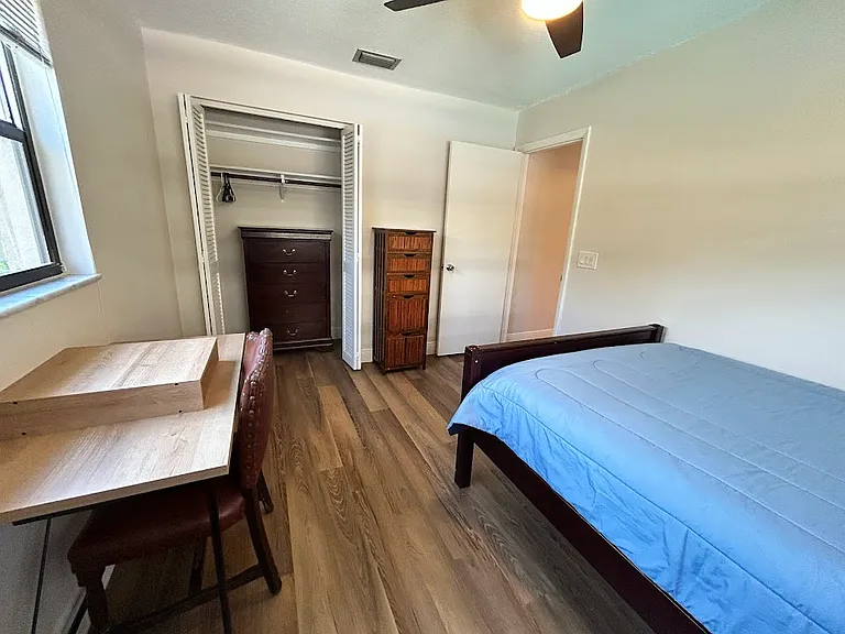 Bedroom 1 - full mattress, desk and chair, side table with lamp, chair, dresser