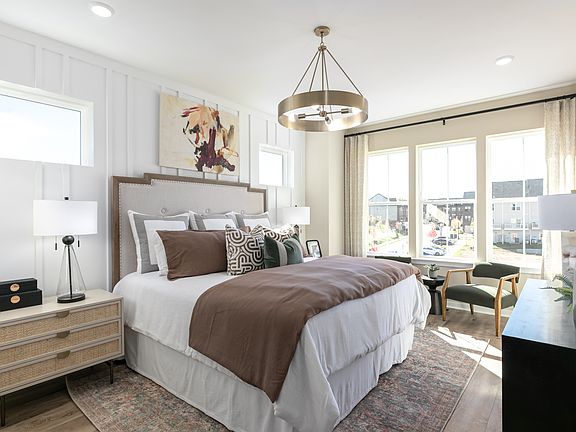 A serene master bedroom featuring large windows for a calming retreat.