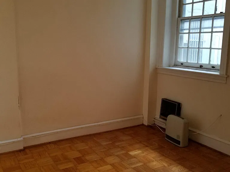 Bedroom with hardwood floor N/facing window