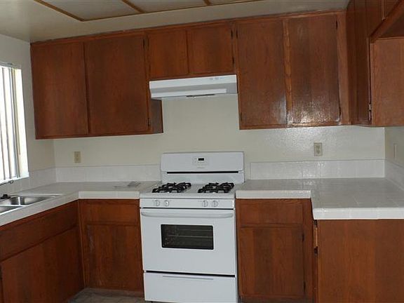 KITCHEN WITH A STOVE AND 
EXHAUST HOOD