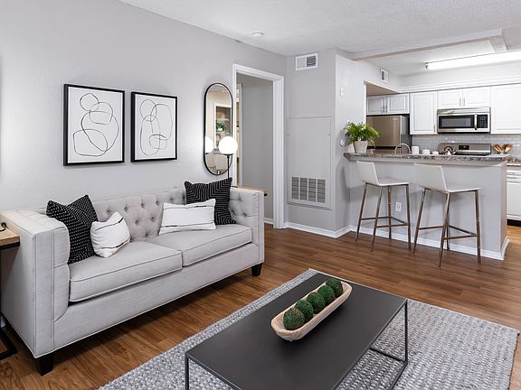 Enjoy the inviting feel of this open-concept living area featuring wood-style flooring, modern finishes, and a seamless flow into the kitchenperfect for hosting or relaxing.