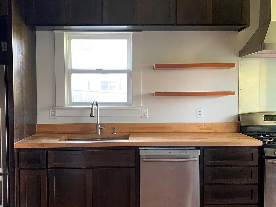 Galley kitchen with butcher block countertops, Bosch dishwasher, solid whit oak shelving. LOTS of kitchen storage.