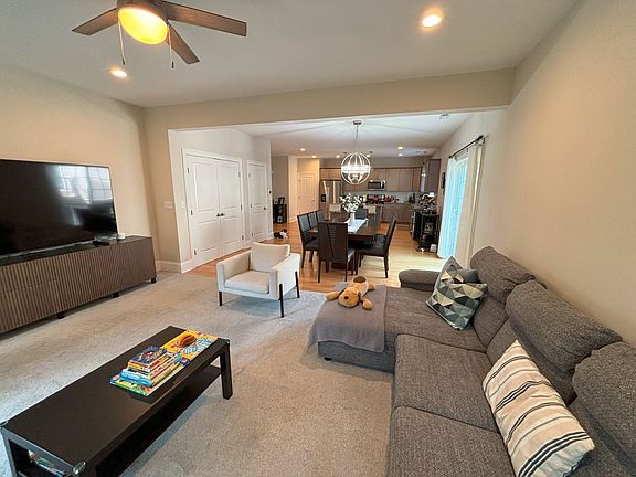 Main floor, living room and dining room open floor concept. Carpet and hardwood flooring.