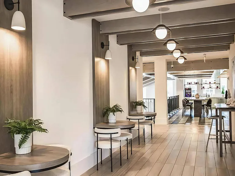 Community Loft Space Featuring Built-In Tables, Cozy Chairs & Coffee Bar Access