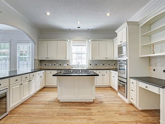 Stainless steel Bosch appliances, double oven and island cook-top make the kitchen a chef's dream come true!