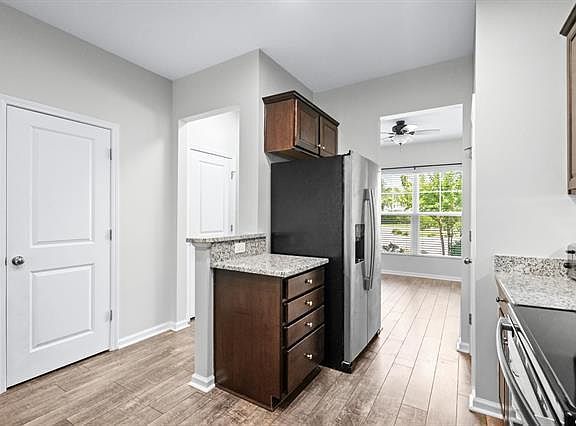 Kitchen with pantry closet on the left and half bathroom off the hallway