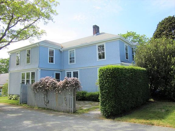 Side entrance and stone patio