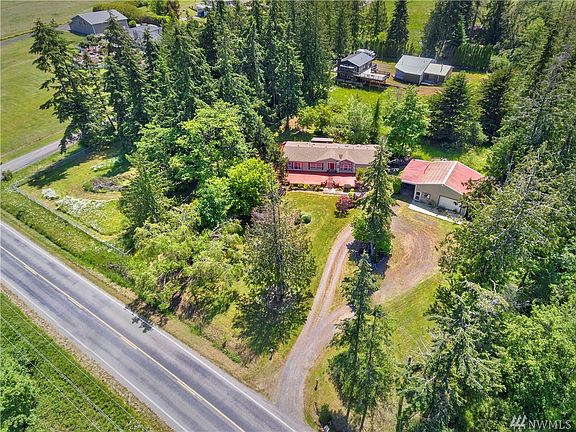 Over one acre of fully-fenced property includes a private park on the corner, forest of trees beyond, and plenty of off-street parking.