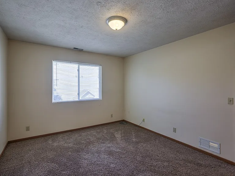 Large bedroom with carpet at Gretna Oaks.