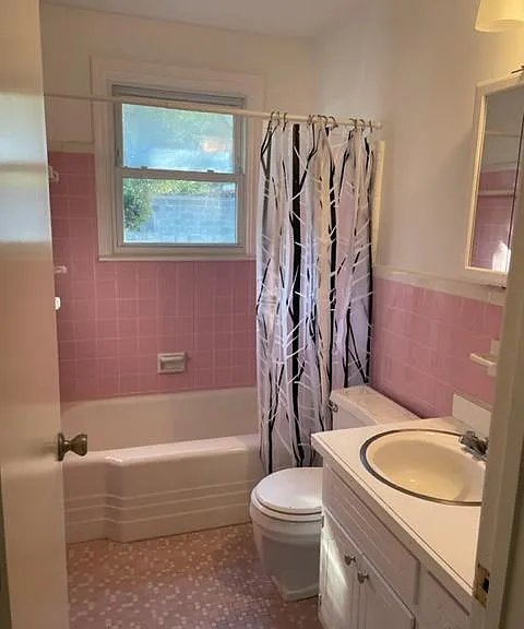 Full bath with tub, vanity and linen closet.