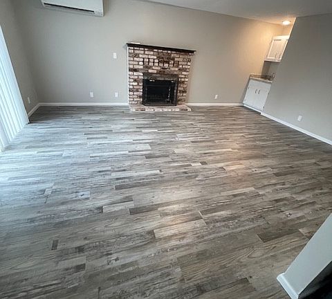 Living room with sliding glass door to backyard, new mini-split, fireplace and wet bar