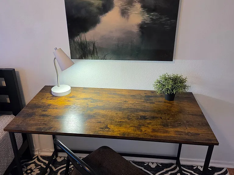 Dedicated workspace with a sturdy desk, task lighting, and comfortable seatingideal for studying or working from home.
