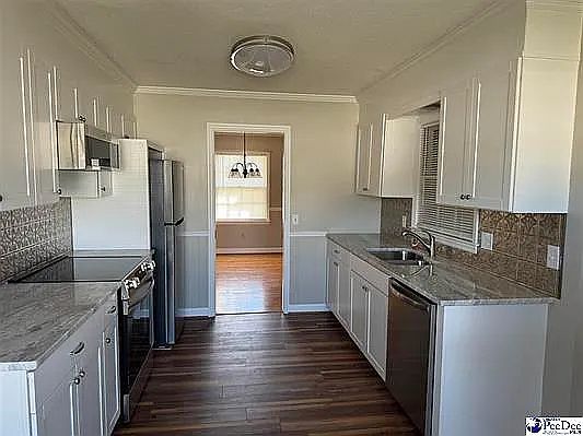 Kitchen with granite countertops, backsplash, and new appliances