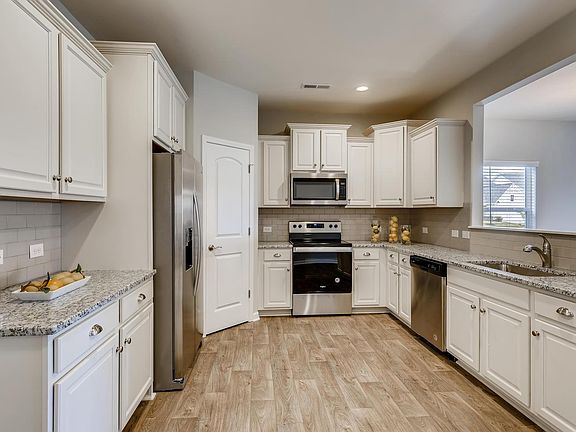 Beautiful linen color cabinetry and granite counters.