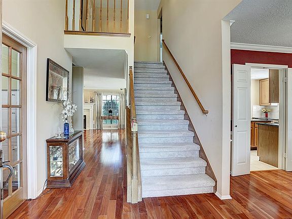 As you enter, there is a private study behind French doors to the left and the elegant formal dining room is to your right.