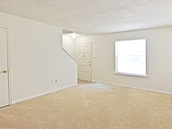 Our two bedroom townhome living room is open and feature a half bath on the ground level.