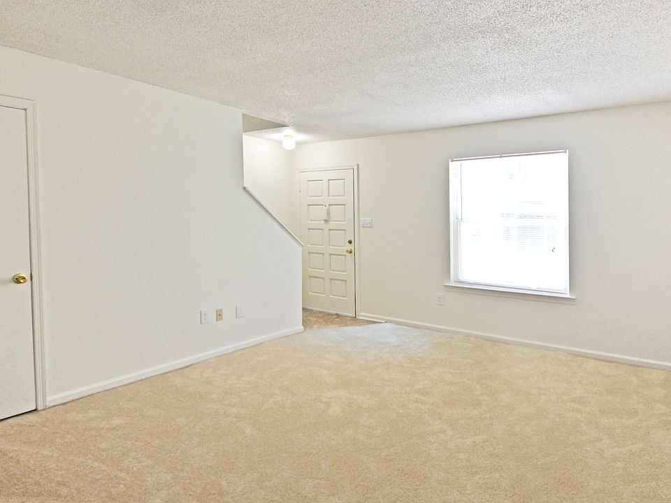 Our two bedroom townhome living room is open and feature a half bath on the ground level.