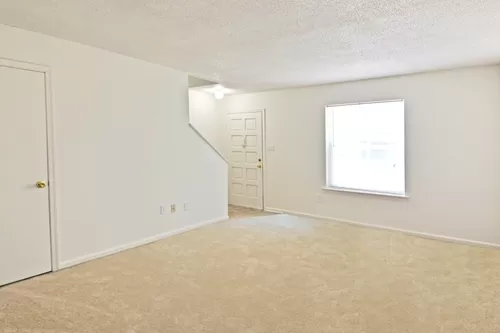 Our two bedroom townhome living room is open and feature a half bath on the ground level. - Countryside Villa Apartments