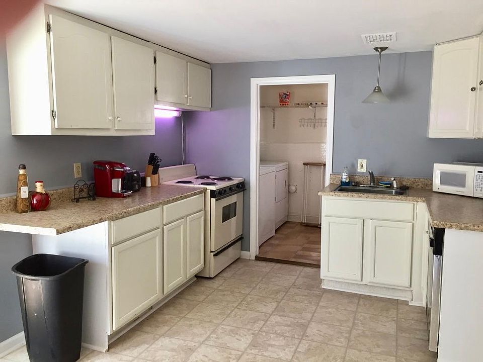 Kitchen supplied with cookware, dishes, microwave, dishwasher, electric range