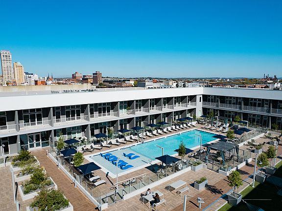Building 3 Rooftop Amenity Deck with Pool/Cabanas, Yard Games, and Dining Spaces