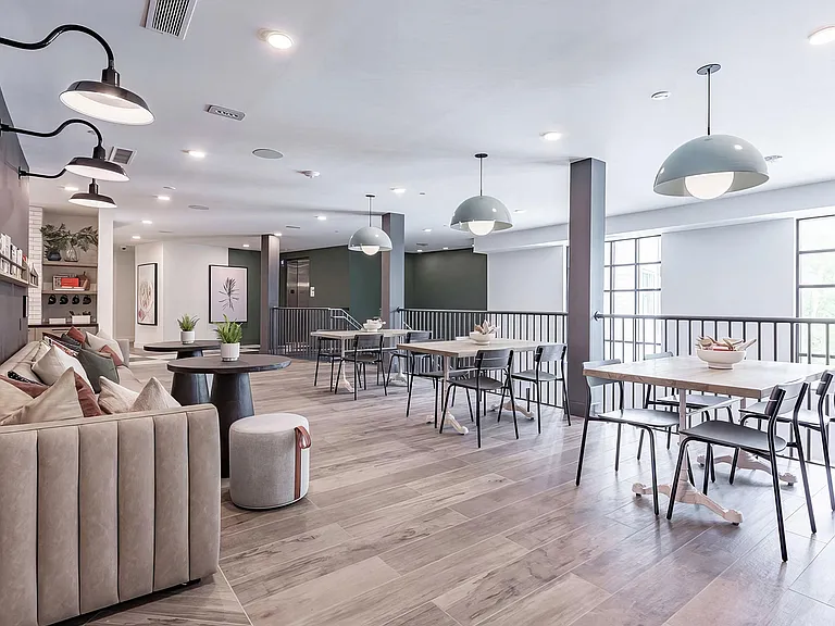 Two-story social area with abundant seating and natural light