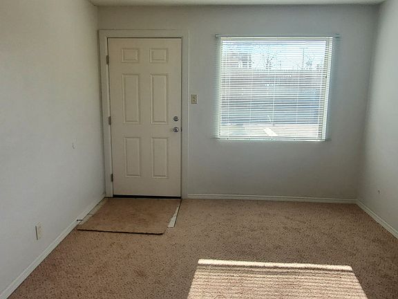Living room space, window and main door entrance.