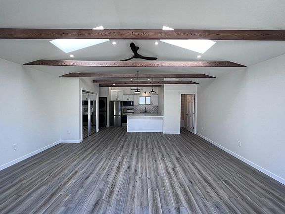 Living space looking into kitchen and bathroom