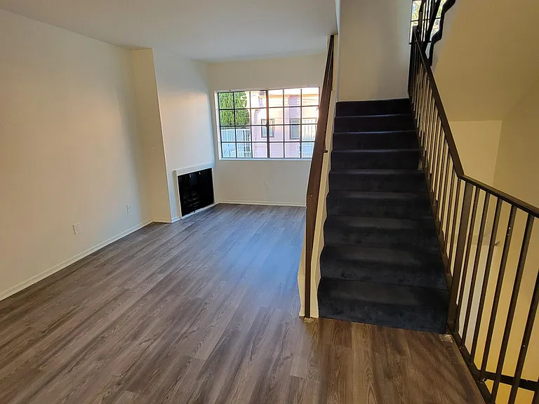 Living Rm, Gas Fireplace, Window View and Stairs to Bedrooms/Bathrooms
