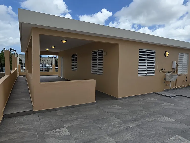 Large back patio which comtains a washer hookup and a wash basin as well as hot and cold water available outside.