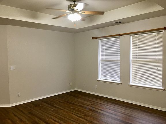 Spacious living room with laminate floors for easy cleaning.