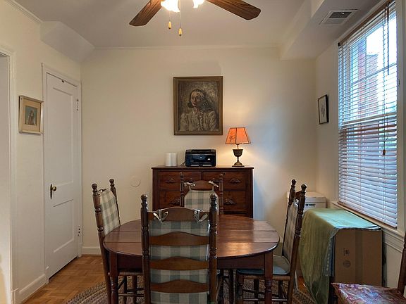 Dining room with lighted ceiling fan.