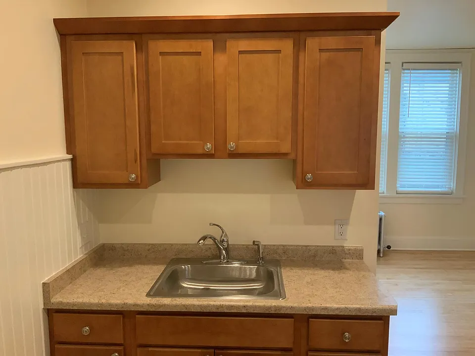 New kitchen counter, sink and cabinets view #2.