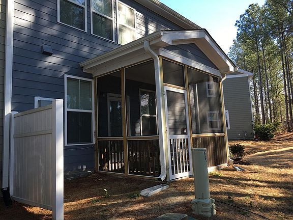 Private screen porch backing to wooded buffer.