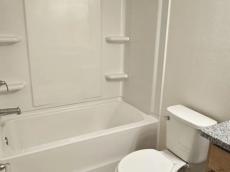 Full bathroom with tub/shower combination, with neutral finishes.