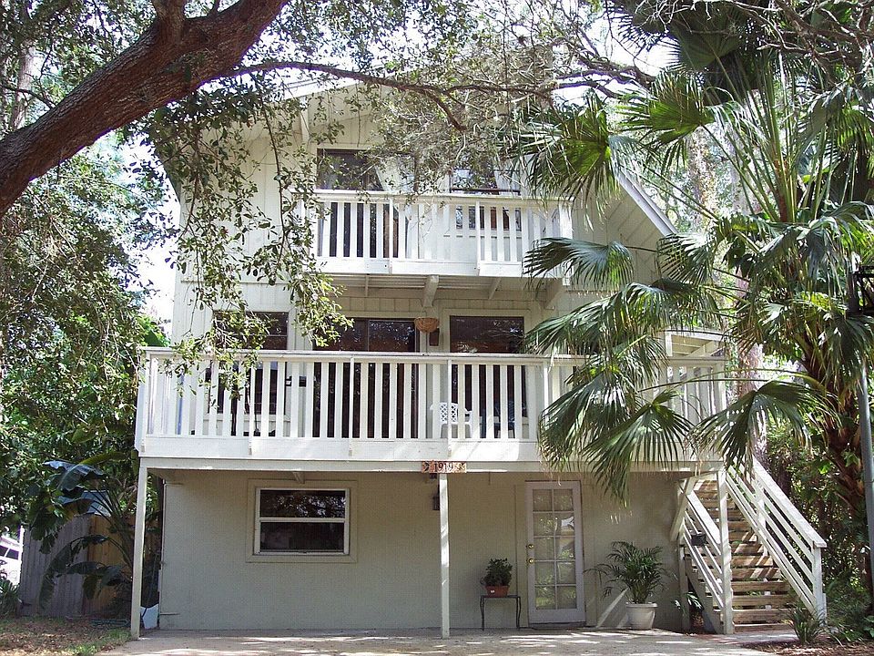 Cottage under the trees across from Bay