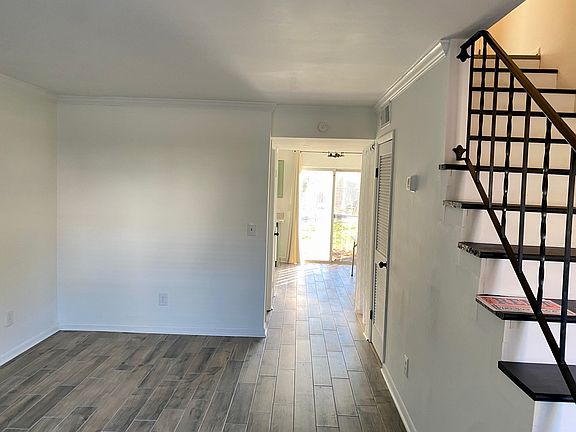 Living Room and Hallway to Kitchen. 1/2 Bath on the left. Laundry on the right.