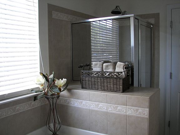 Custom tile and oversized garden tub in master bathroom