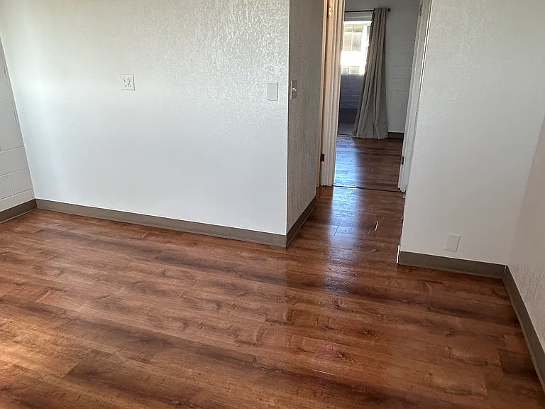 Living room with hallway leading into bedroom #2